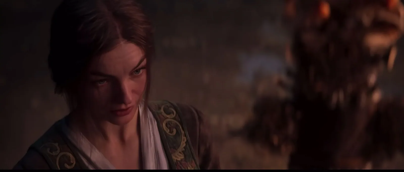 An unnamed short-haired figure in conversation, official Divinity trailer at 01:05.